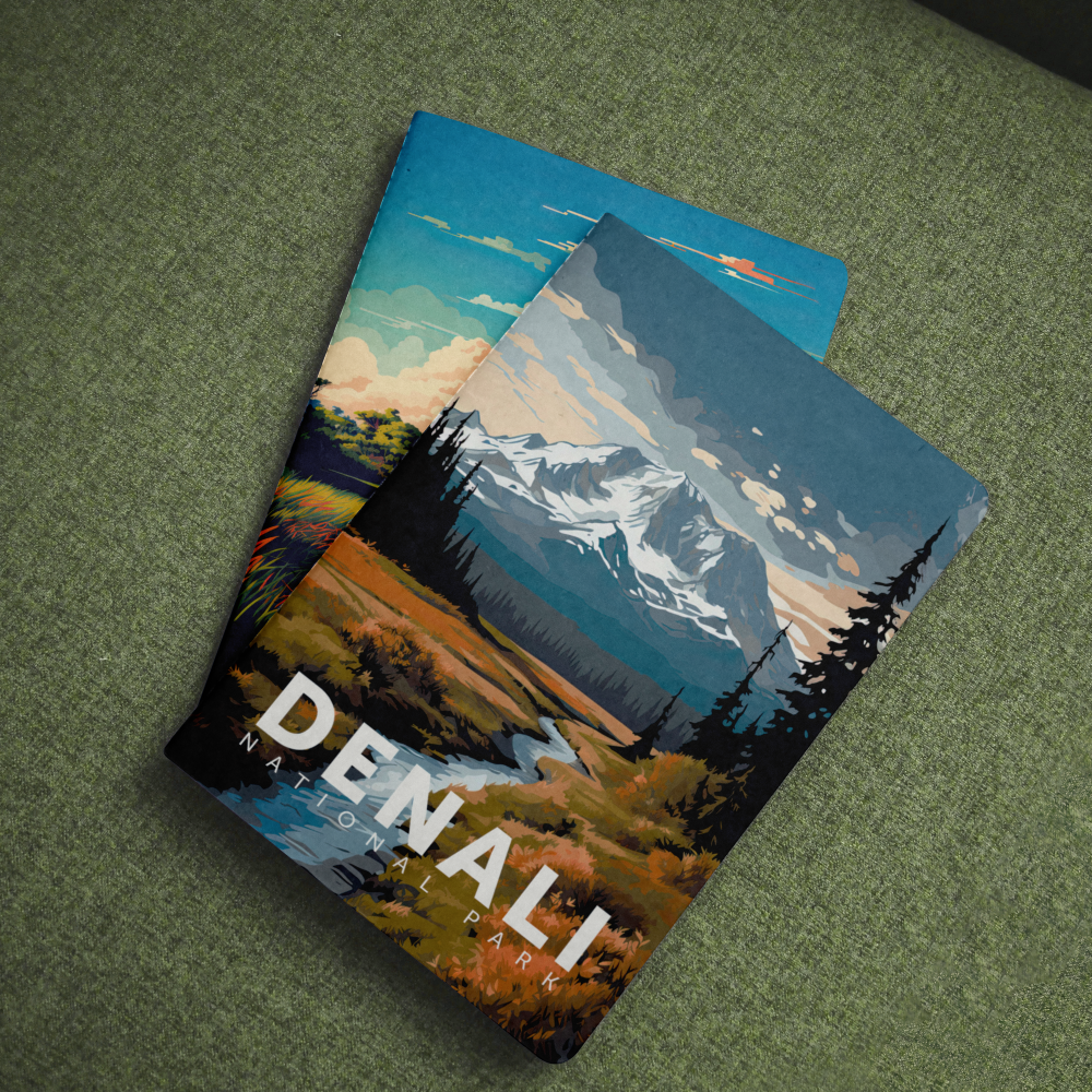 Denali National Park pocket notebook with a snowy mountain cover lying on green fabric.