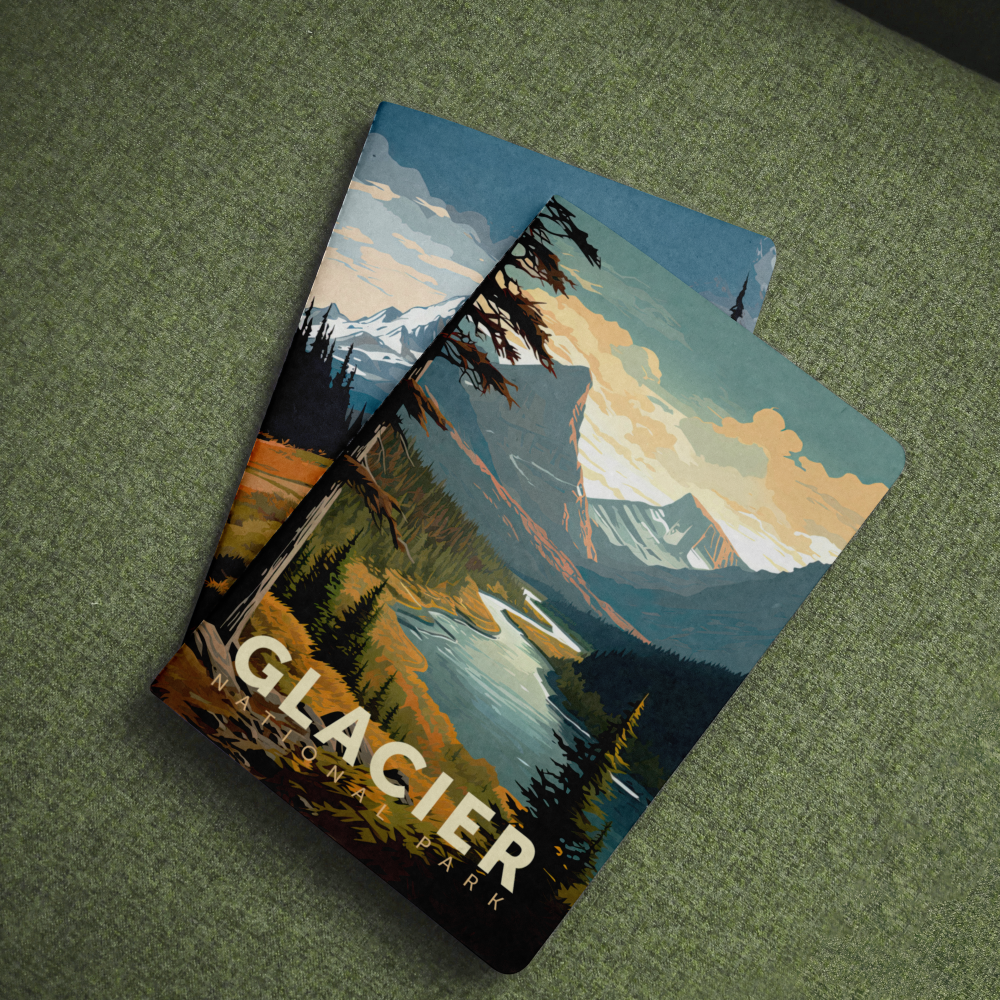 Glacier National Park pocket notebook with a mountain lake cover lying on green fabric.