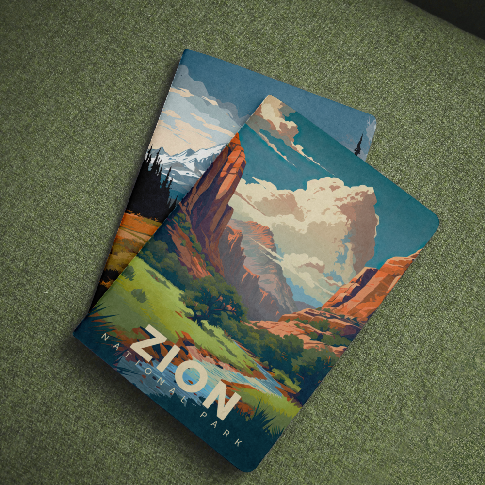 Zion National Park pocket notebook with a red rock canyon cover lying on green fabric.