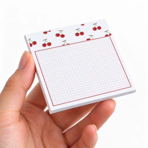 Cherry Header Grid sticky note pad on a desk with stationery
