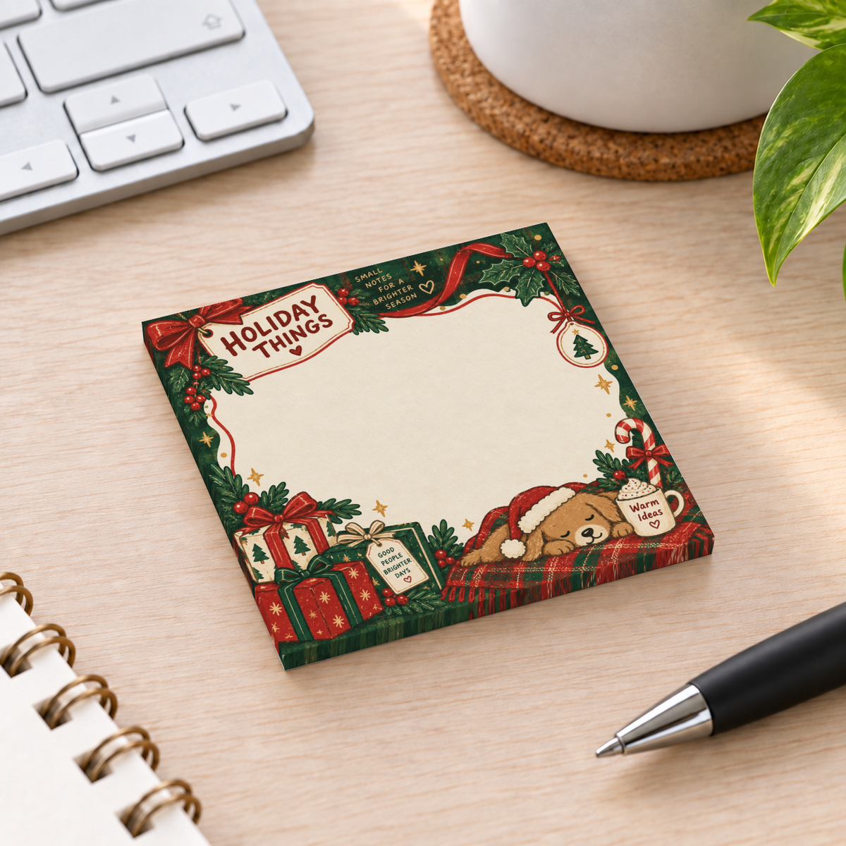 Holiday puppy and presents sticky note pad with a sleeping dog, gifts, and holly on a desk beside a pen.