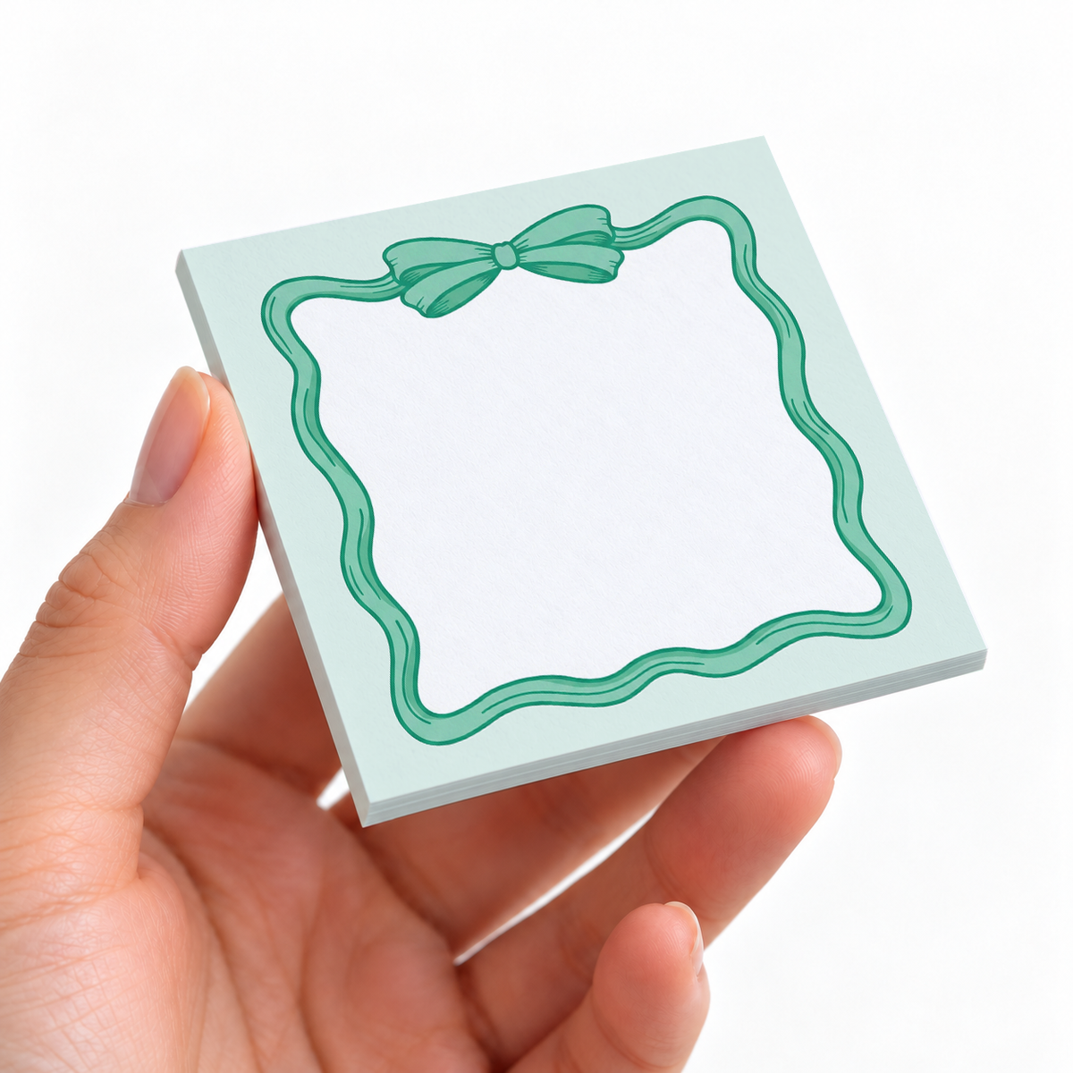 Mint Green Coquette Bow sticky note pad on a desk with stationery
