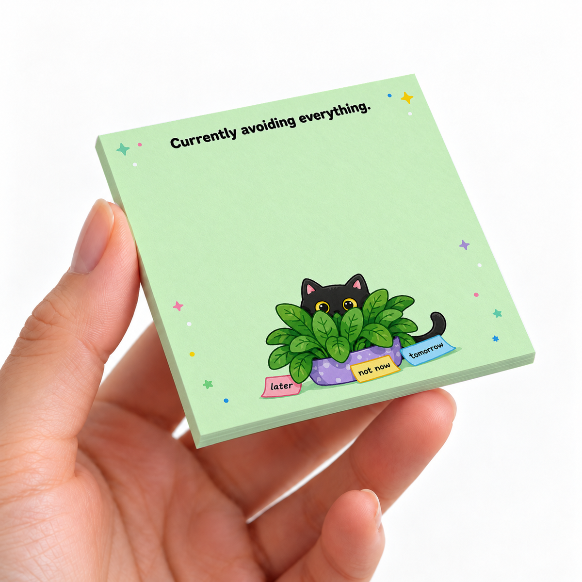 Avoiding Everything Plant Hiding Cat sticky note pad on a desk with stationery