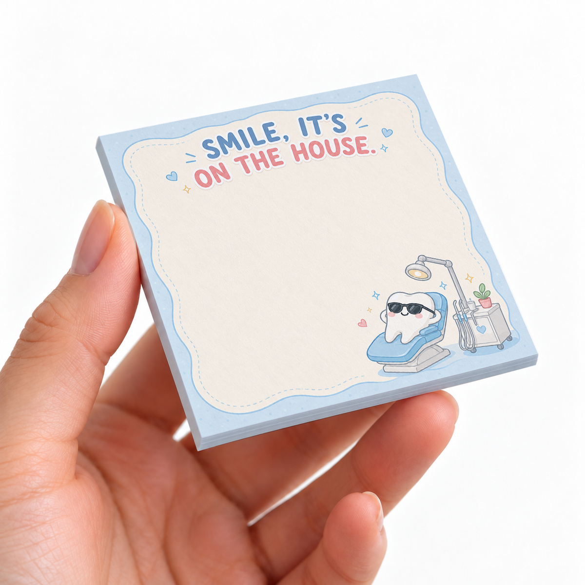 Smile It's On The House Dental sticky note pad on a desk with stationery