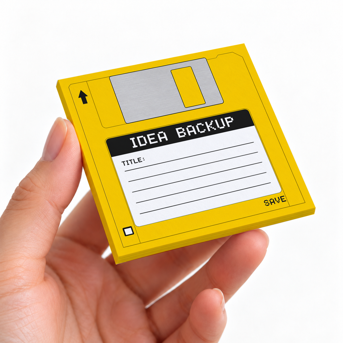 Yellow Idea Backup Floppy Disk sticky note pad on a desk with stationery