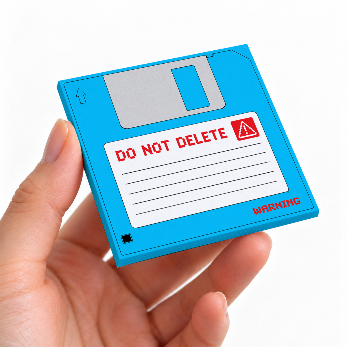 Blue Do Not Delete Floppy Disk sticky note pad on a desk with stationery