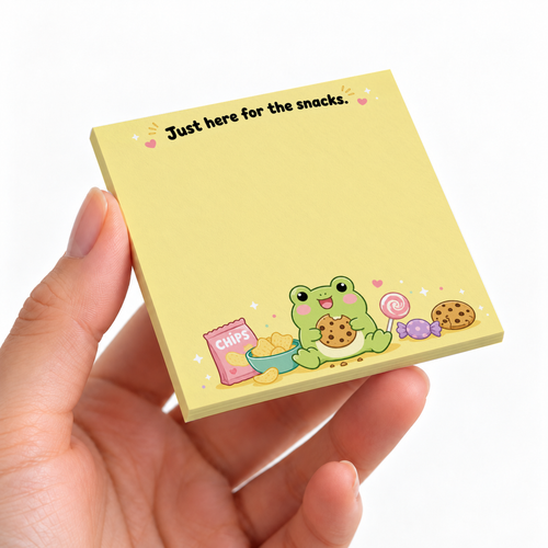 Hand holding a yellow frog sticky note pad with chips, cookies, candy, and “Just here for the snacks.”