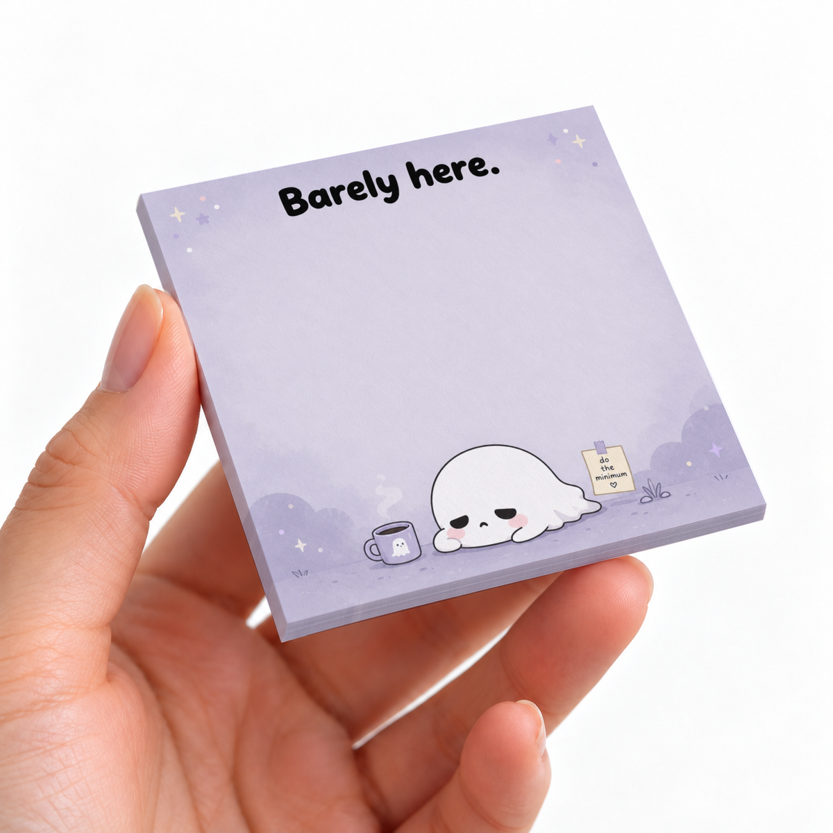 Hand holding a purple 3 x 3 inch sticky note pad with “Barely here.” and a sleepy ghost illustration.