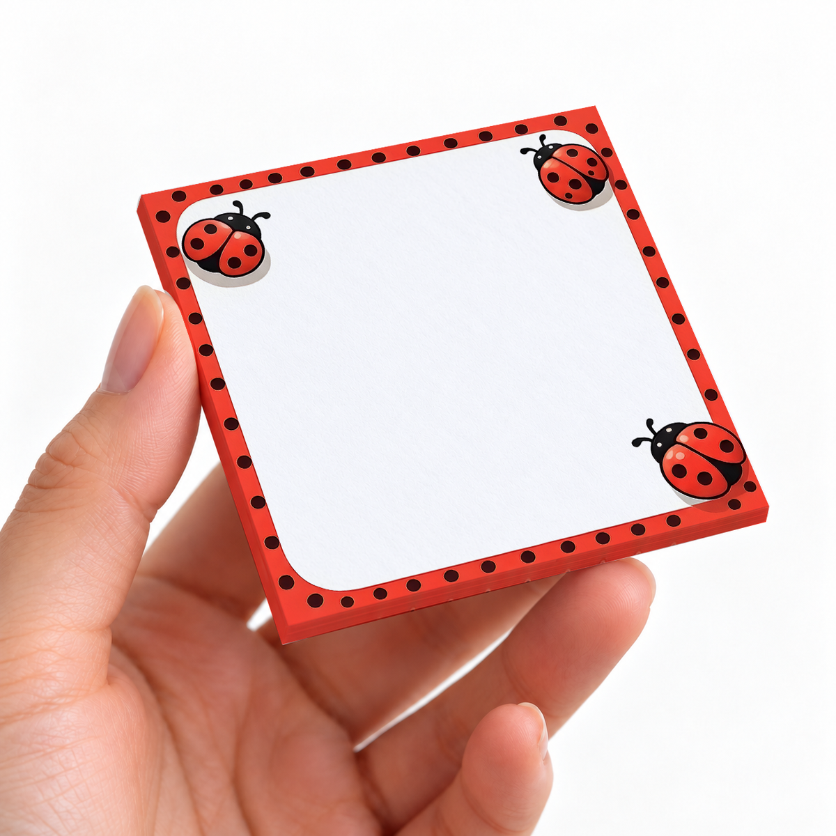 Red Polka Dot Ladybug sticky note pad on a desk with stationery