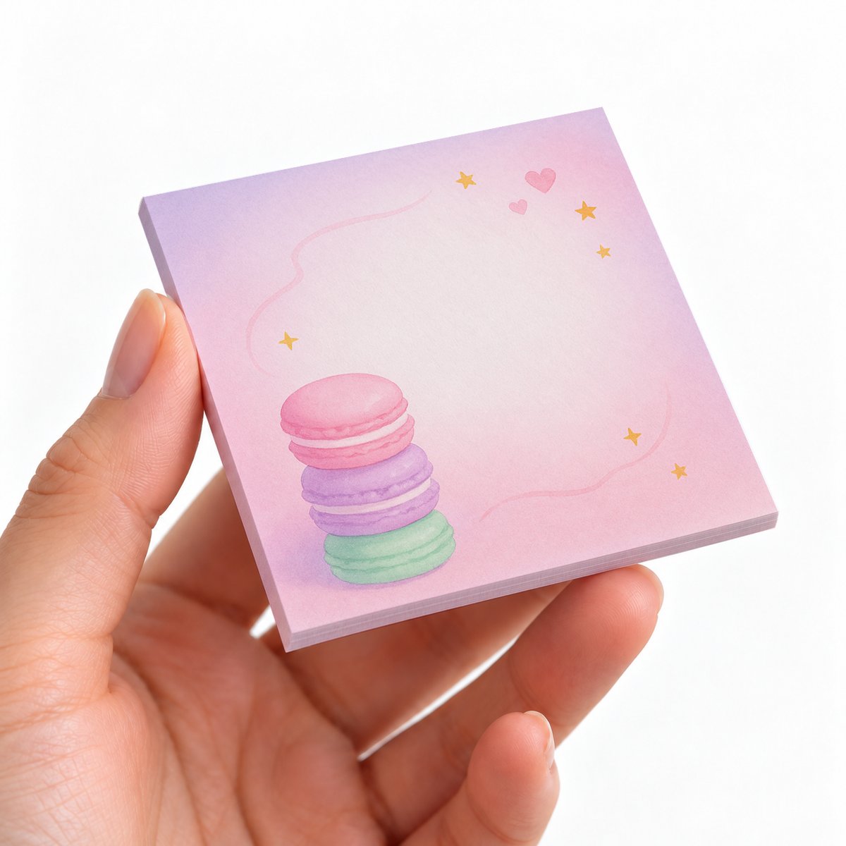 Stacked Macarons Watercolor sticky note pad on a desk with stationery