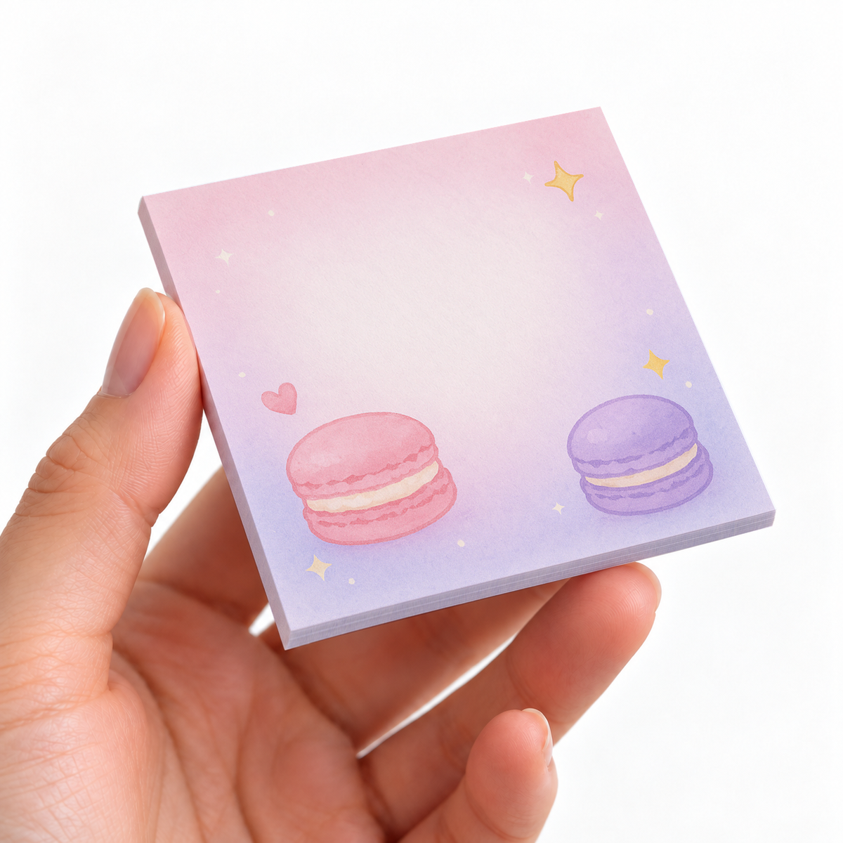Pink and Purple Macaron Duo sticky note pad on a desk with stationery