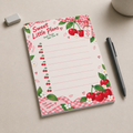 Sweet Little Plans Cherry Memo Pad with a pen and eraser on a desk.