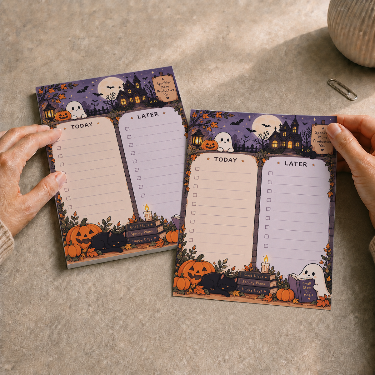 Hands holding a sheet from the Spooky Haunted House Memo Pad over a textured desk.