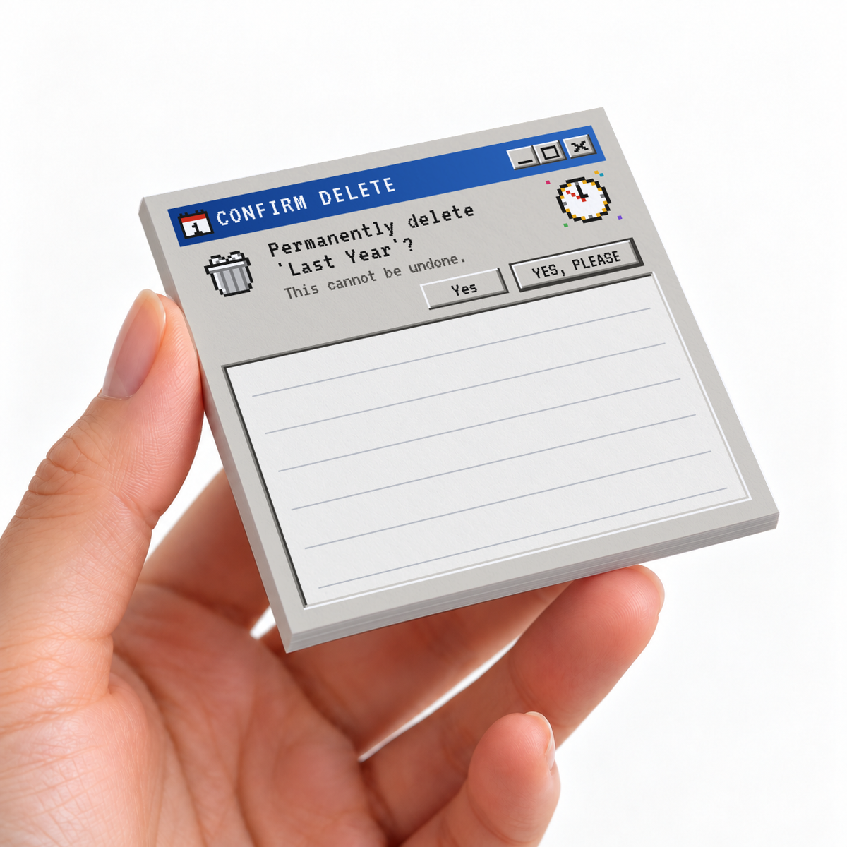 Hand holding a retro computer delete sticky note pad with a “Last Year” prompt and lined writing area.