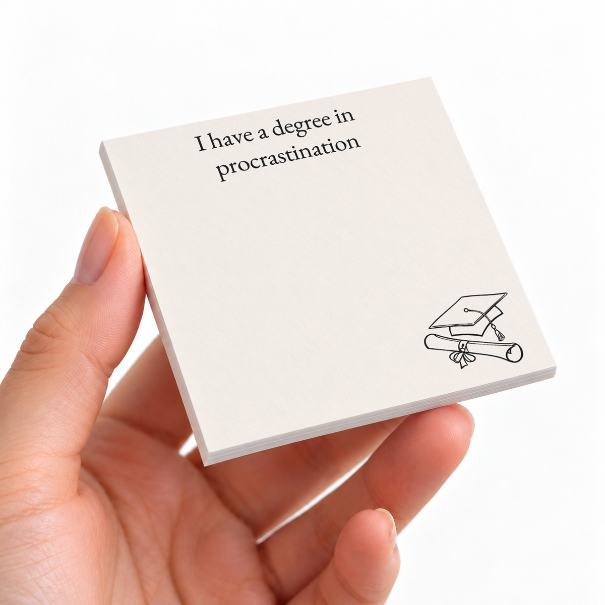 Degree in Procrastination sticky note pad on a desk with stationery
