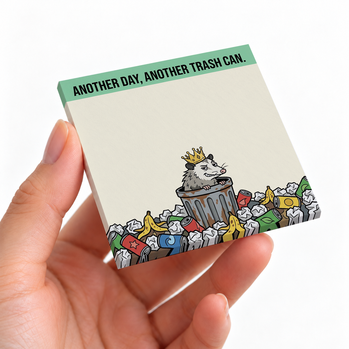 Trash Can King Opossum sticky note pad on a desk with stationery