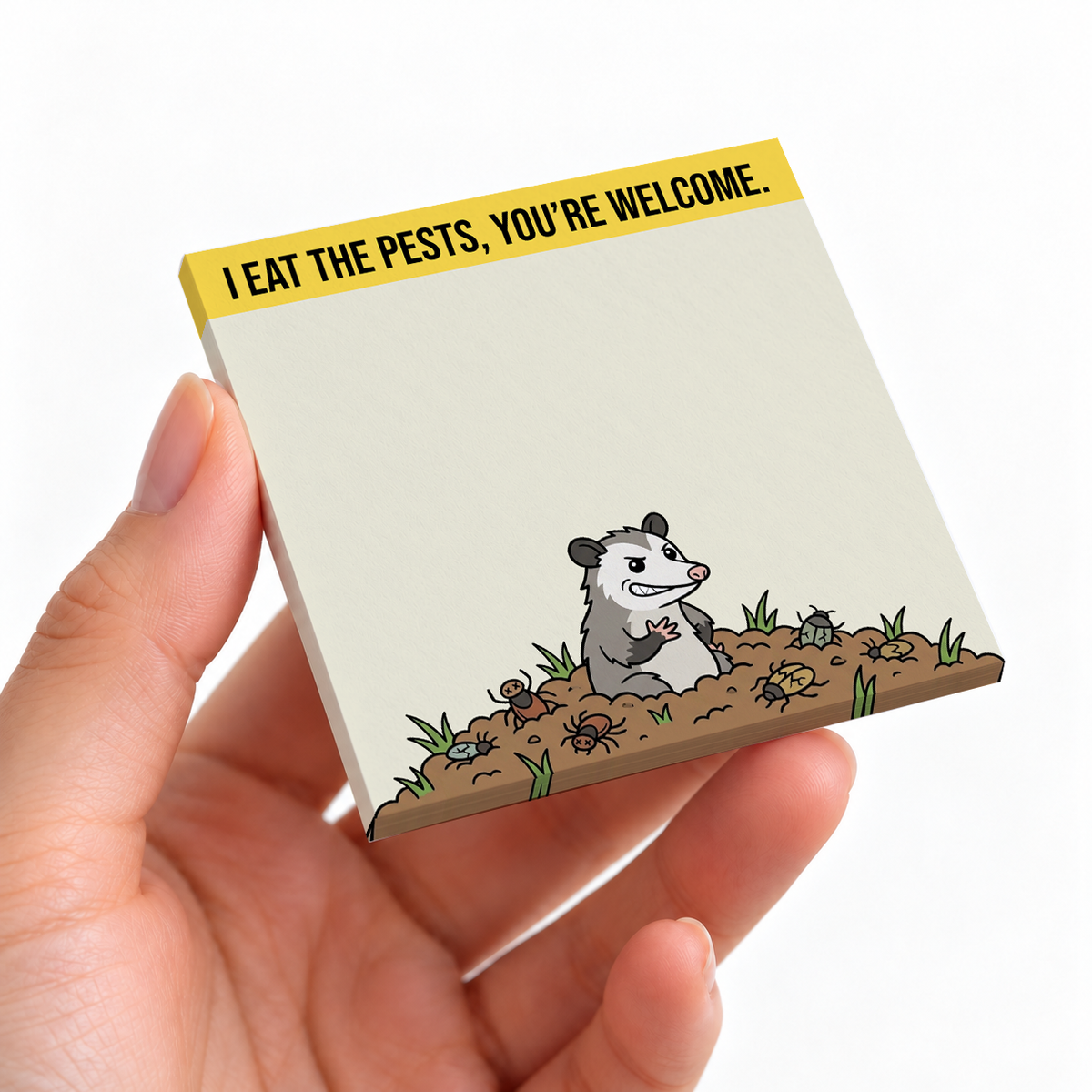 Funny Opossum Eating Pests sticky note pad on a desk with stationery