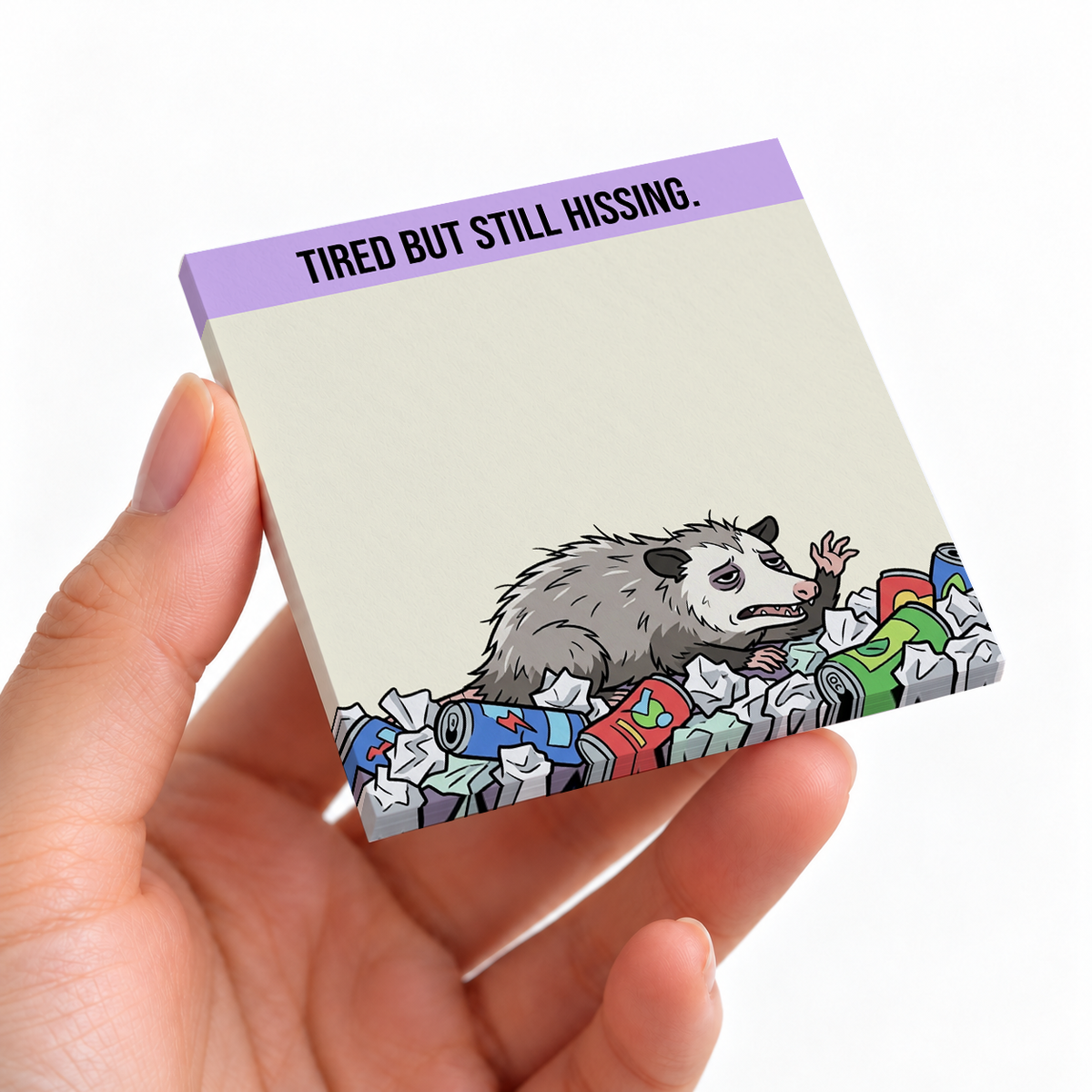 Tired But Still Hissing Opossum sticky note pad on a desk with stationery