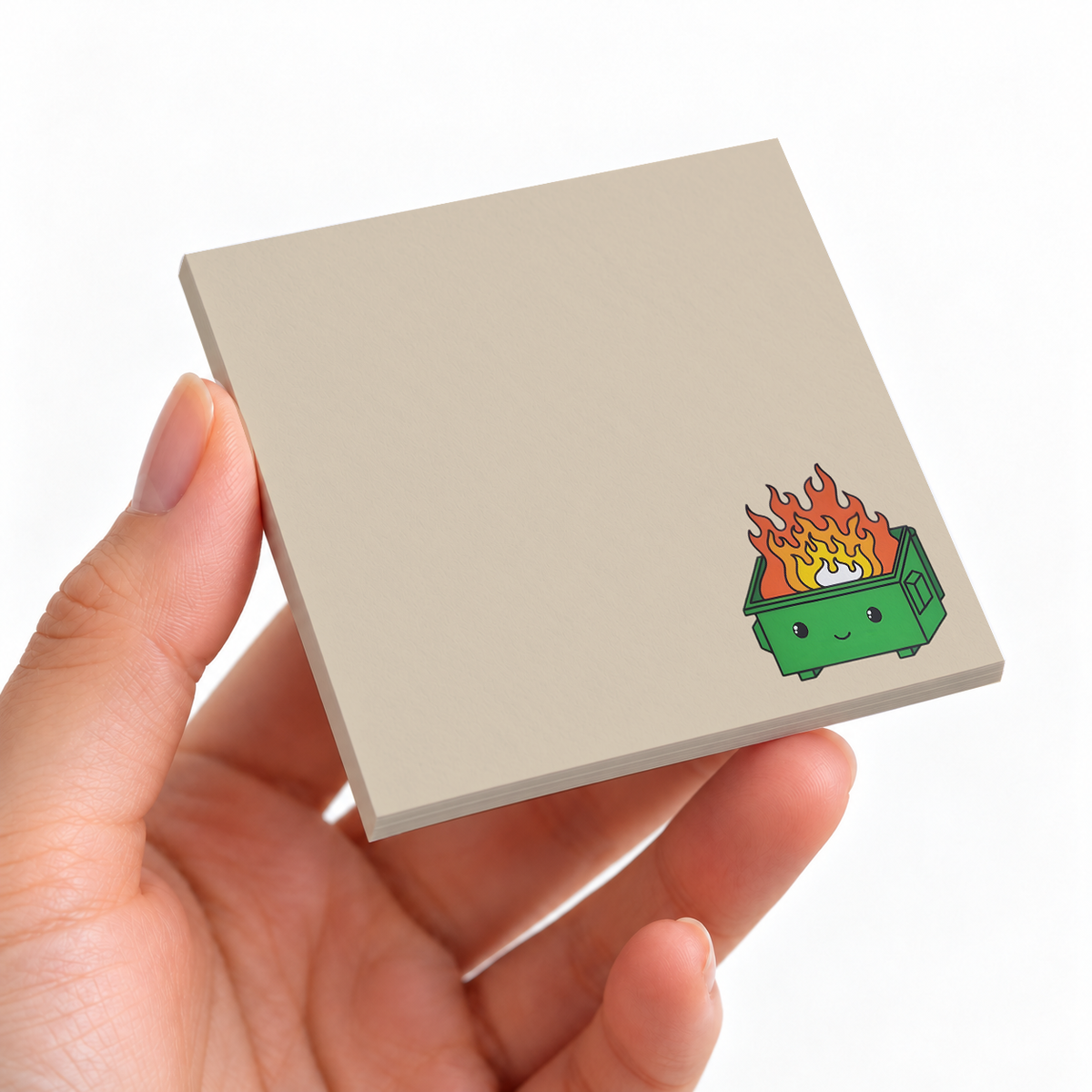 Green Dumpster Fire sticky note pad on a desk with stationery