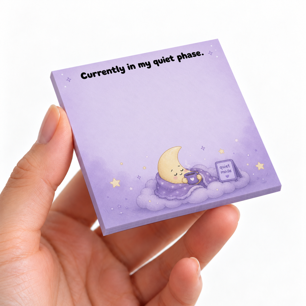 Hand holding a lavender sticky note pad reading “Currently in my quiet phase,” with a sleepy moon on a cloud.