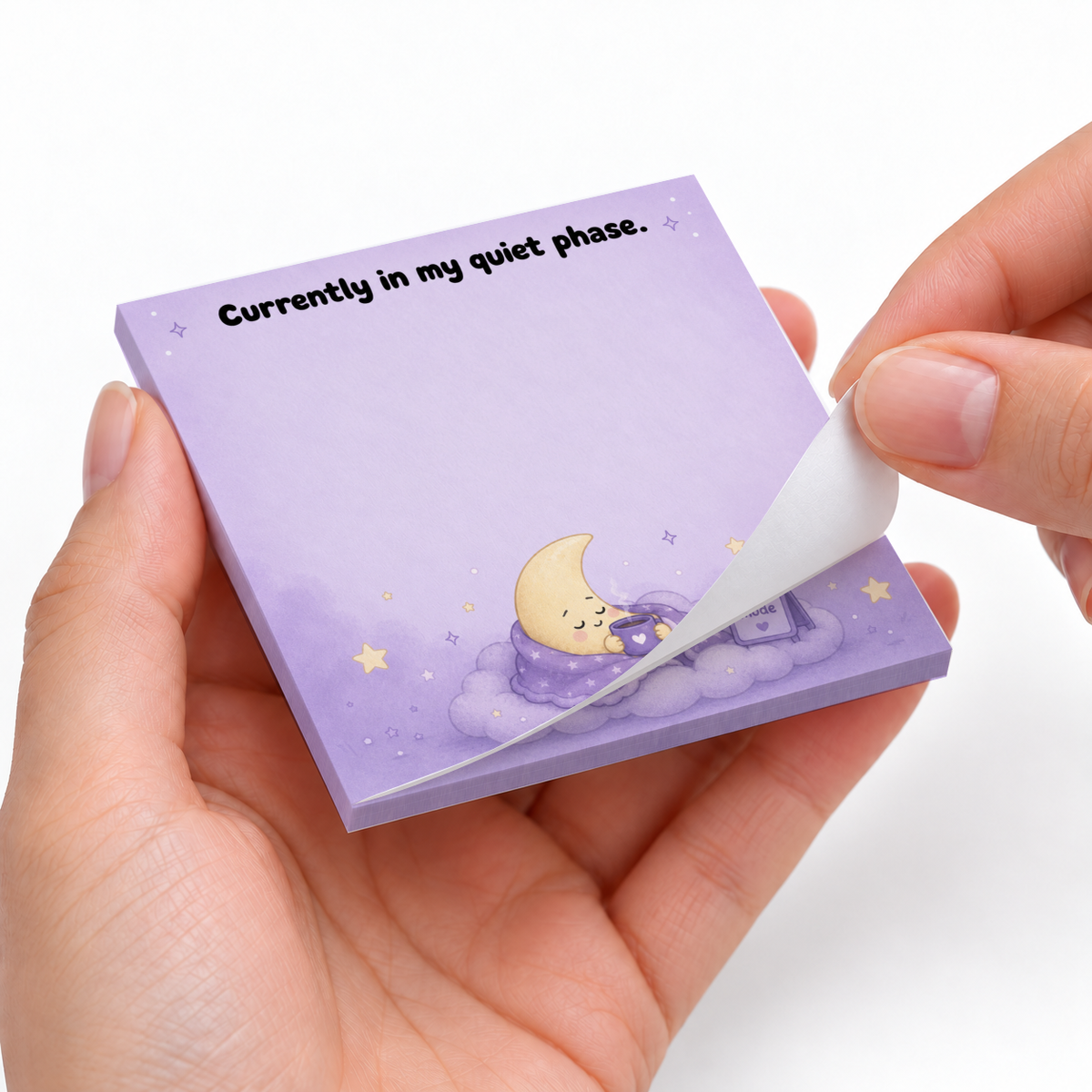 Hands peel a sheet from the purple Currently in My Quiet Phase moon sticky note pad.