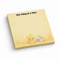 Yellow 3 x 3 inch sticky note pad reading “One thing at a time,” with a cute star illustration on white.