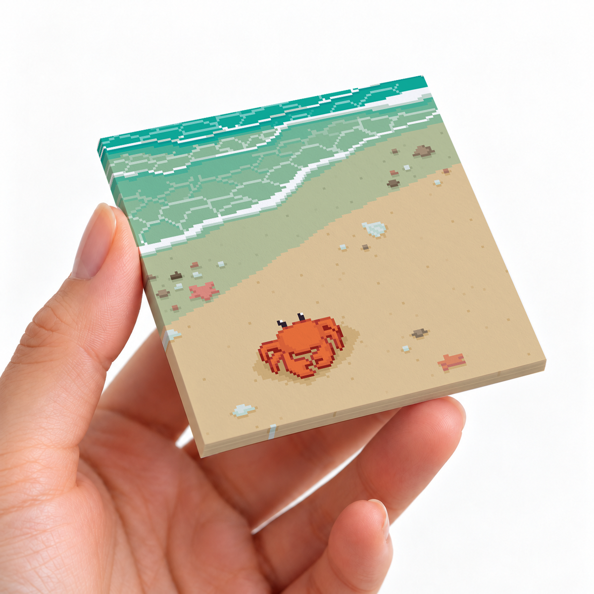 Pixel Art Beach Crab sticky note pad on a desk with stationery