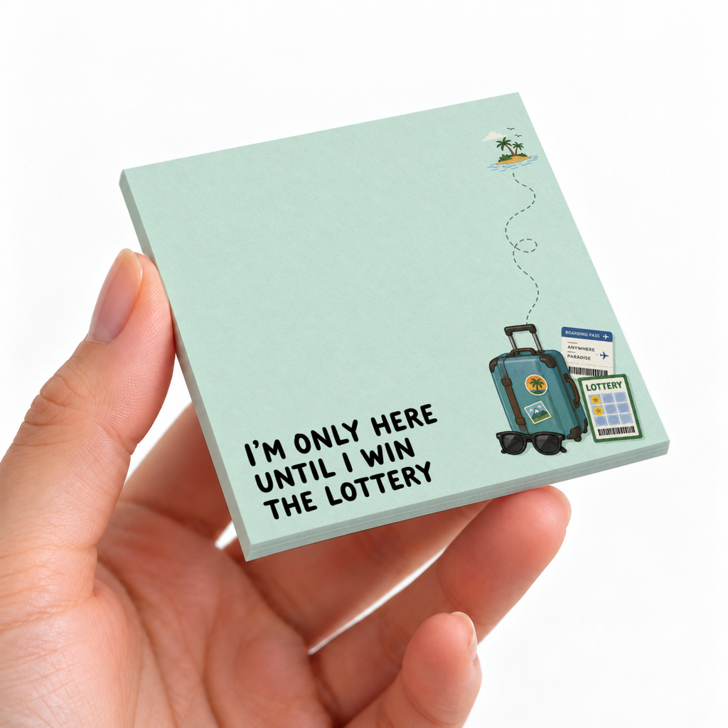 Hand holding a mint green Lottery Vacation sticky note pad with suitcase art and “I’m only here until I win the lottery.”